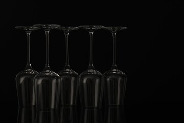 Many empty clean glasses on black background