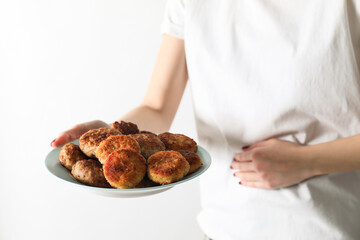 Woman with patties suffering from abdominal pain on white background, closeup. Food allergy concept