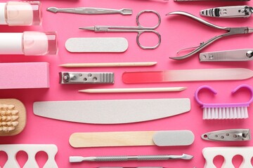 Set of different manicure tools on bright pink background, flat lay