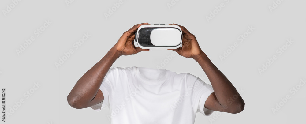 Fototapete a person engages with virtual reality technology using a headset that covers their eyes, creating an