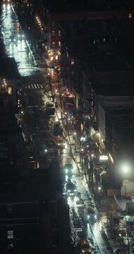 New York City streets, buildings, and traffic during a rainy winter night