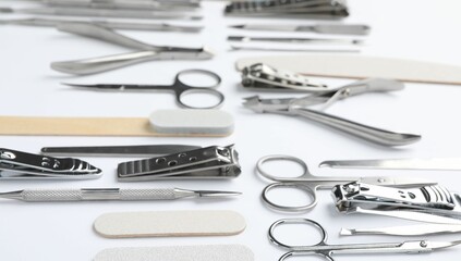 Set of different manicure tools on white background, closeup