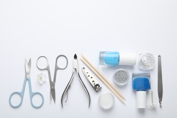 Set of different manicure tools on white background, flat lay. Space for text