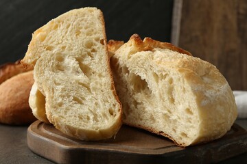Slices of fresh bread on dark table, closeup