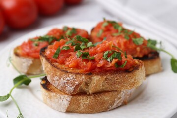 Tasty bread with tomato and parsley on table, closeup