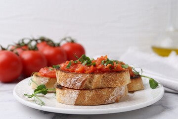 Tasty bread with tomatoes and parsley on white marble table, closeup