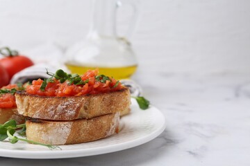 Tasty bread with tomato and parsley on white marble table, closeup. Space for text