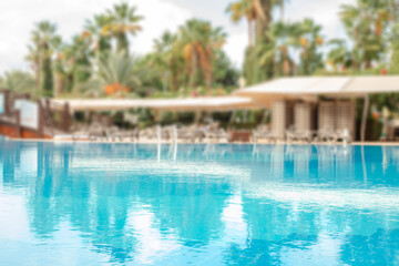 Pool Water Surface Reflecting Clouds and Palm Trees
