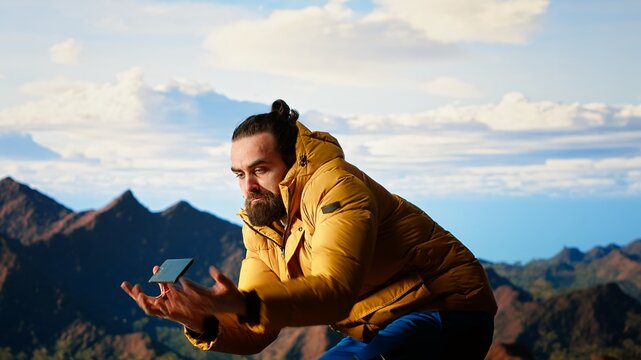 Foolish hiker acting careless dropping smartphone and losing balance, person unequipped for the harsh mountain environment. Risks of trekking with a technology obsession in nature. Camera B.