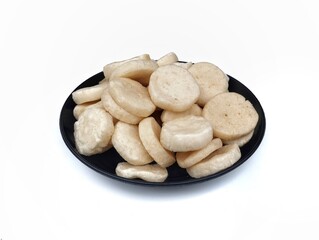 Kerupuk ikan or fish cracker on plate isolated on white background 