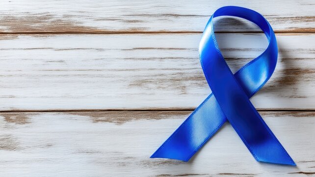 Blue awareness ribbon on wooden background, symbolizing support and