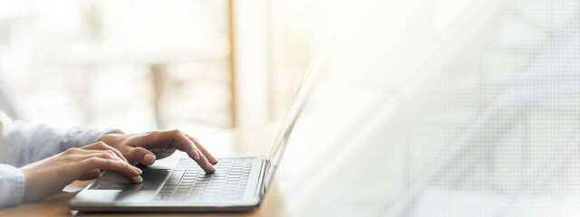 Woman hands typing on laptop over blurred background, side view, freelance concept, cropped, empty...