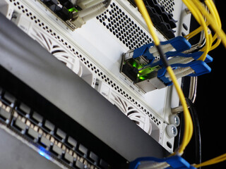 Detailed View of Network Equipment and Fiber Optic Cables in Rack