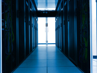Dark Server Room Corridor with Network Wires and Open Doors