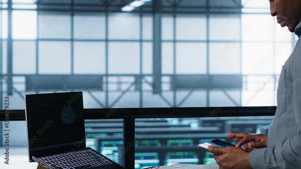 Poster technician in data center with laptop and tablet integrating ai driven automation tools. server room