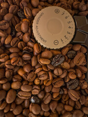 Automatic coffee grinder grinds coffee beans. Beautiful coffee beans fresh roasted coffee beans in a coffeemaker bean container.