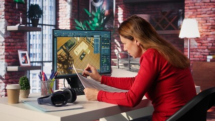 Remote worker in creative office uses CAD software and blueprints plan, design a house interior and provides a user interface for virtual home customization. Detailed architectural layout. Camera B.