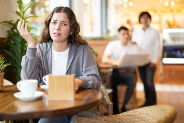 Upset girl resting at table in cafe, drinking coffee. Nasty news, consequences of conflict, bad...