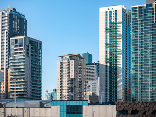 The dense, modern urban skyline of Melbourne, Australia, featuring a cluster of high-rise...