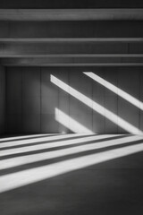 Obraz premium Sunlight creating striking patterns on a minimalist interior space during midday