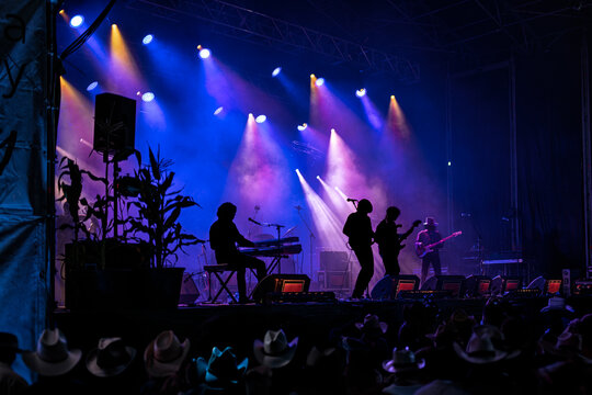 Country Music Concert Performance with Band and Colorful Stage Lighting
