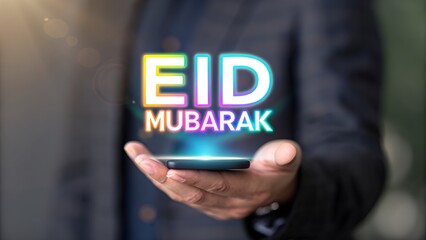 Eid Greetings, Eid Mubarak,  A man holding holographic "Eid Mubarak text"