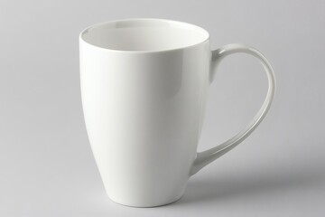 Obraz premium Elegant White Ceramic Mug for Beverage Consumption on Neutral Background