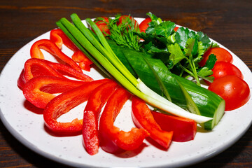 Fresh vegetables arranged beautifully on a plate for salad preparation