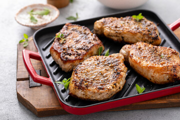 Pork chops with herbs and garlic grilled or sauteed on a pan