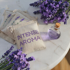 Delicate lavender sachets are arranged next to a small bottle of lavender essential oil, creating an atmosphere of tranquility and relaxation, showcasing nature's soothing gifts.