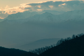 Central massif of Gredos at sunset. Lines of mountains on the horizon with orange and cyan blue...