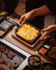 friends share food at a korean bbq restaurant 