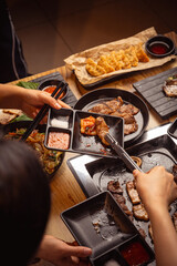 friends share food at a korean bbq restaurant 