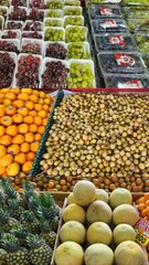 Various fresh and colorful fruits are displayed in a market