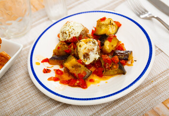 Fried meatballs with aubergine and melted cheese, served with stewed vegetables and bread