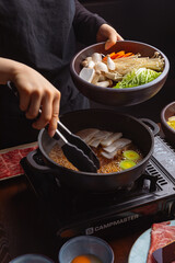 woman in a japanese hotpot restaurant