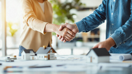 Professional Meeting with Architectural Plans and Miniature Houses