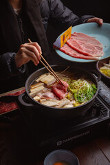 woman in a japanese hotpot restaurant