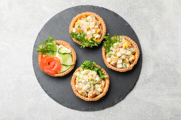 Tartlets with delicious fillings on grey table, top view