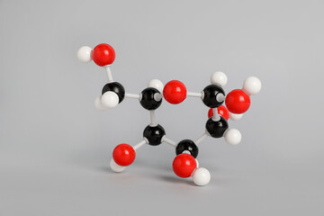 Molecule of glucose on light grey background. Chemical model