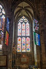Obraz premium Flags of Knights of the Thistle hang in the interior of St Giles Cathedral. Edinburgh. Scotland