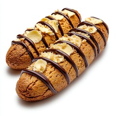 Two Brown Pastries Drizzled with Chocolate and Topped with White Chocolate Shavings on White