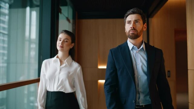 Successful partners walking office hallway together closeup. Confident man woman