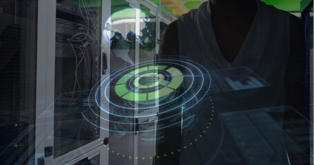 Analyzing digital interface, engineer focusing on futuristic technology in data center