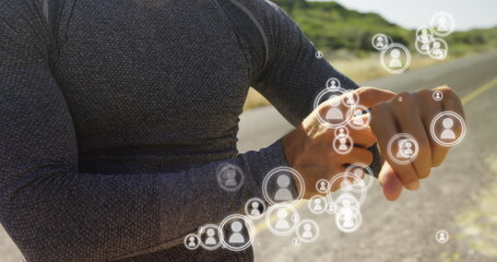 Athlete on road using smartwatch with digital social network icons overlay