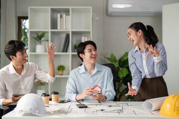 Collaboration and Creative Discussion. A vibrant team exchange ideas over architectural concepts and designs.