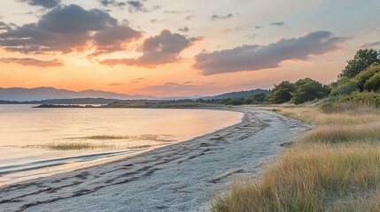 Obraz premium Serene Summer Sunset Over Calm Beach with Soft Color Palette
