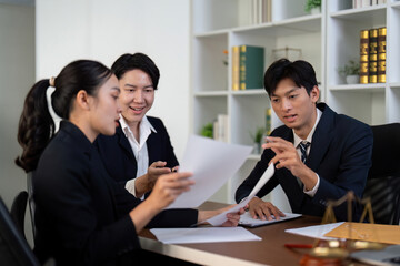 Collaboration and Legal Discussion. A team of lawyers collaborating on important case files.