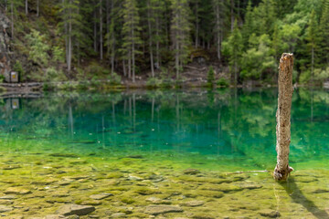 Breathtaking views of the upper and lower Grassi Lakes with brilliant turquoise and aqua waters set in a serene wilderness outside the town of Canmore near Kananaskis during the summer season