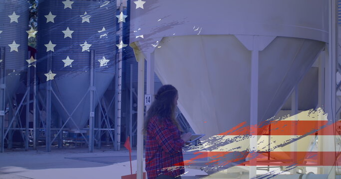 Woman in plaid shirt using tablet at industrial facility with American flag overlay